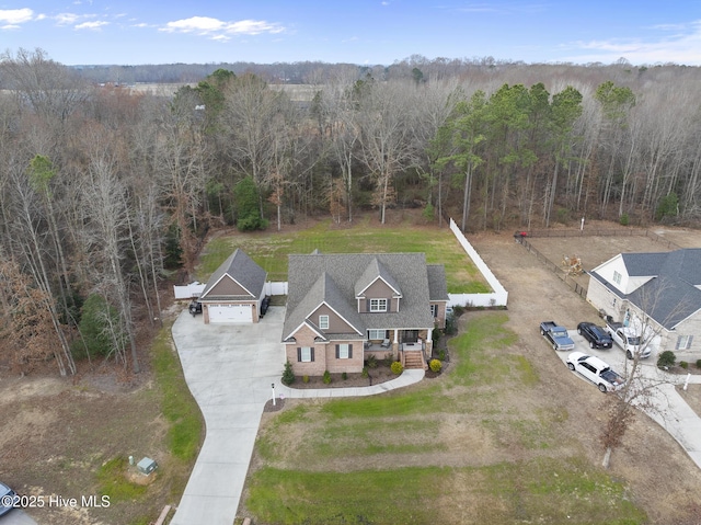 birds eye view of property with a view of trees