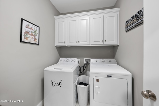 washroom with washing machine and dryer and cabinet space