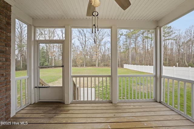 unfurnished sunroom with ceiling fan and wooden ceiling