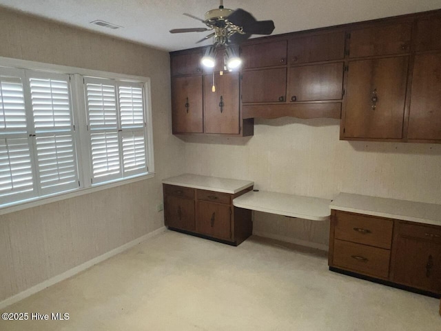 kitchen with baseboards, visible vents, light countertops, and a ceiling fan