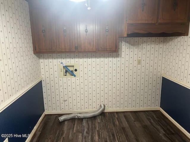 laundry area with dark wood-style flooring, washer hookup, cabinet space, and wallpapered walls