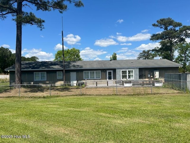rear view of property featuring a yard and fence private yard