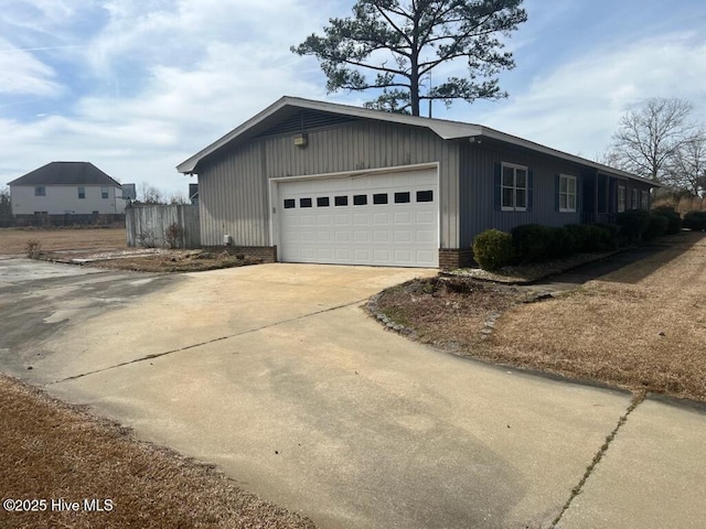 view of home's exterior featuring a garage, driveway, and brick siding