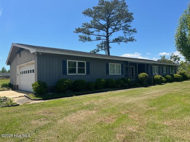 ranch-style house with an attached garage, driveway, and a front lawn
