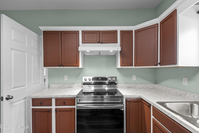 kitchen with under cabinet range hood, stainless steel range with electric cooktop, and a sink