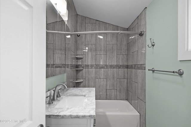 full bathroom featuring vanity, bathing tub / shower combination, and lofted ceiling