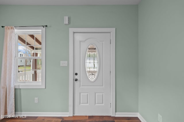 entryway featuring baseboards and wood finished floors