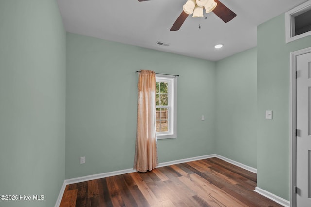 unfurnished room featuring visible vents, baseboards, wood finished floors, and a ceiling fan