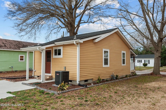 view of side of property with entry steps, central air condition unit, and crawl space