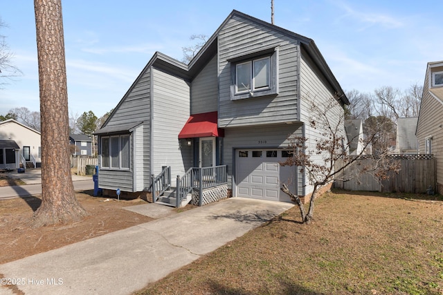 view of front of property with a garage, driveway, a front yard, and fence