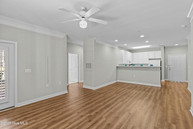 unfurnished living room featuring baseboards, visible vents, ceiling fan, crown molding, and light wood-type flooring