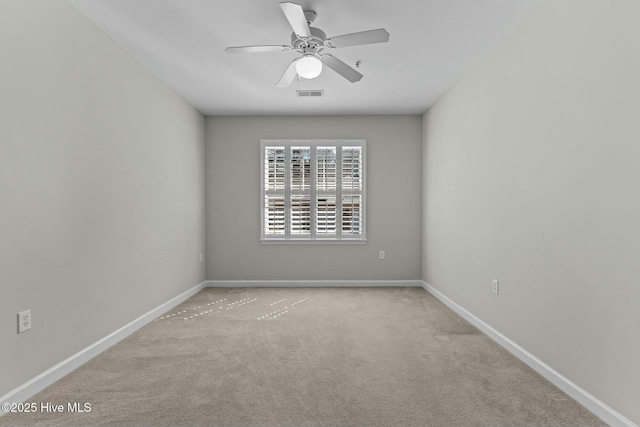 unfurnished room with a ceiling fan, carpet flooring, visible vents, and baseboards