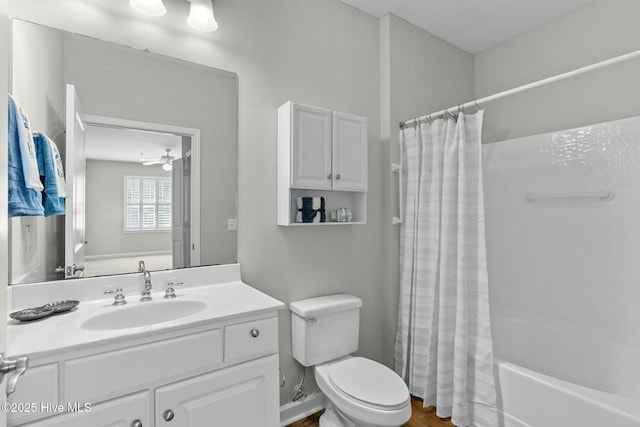 bathroom featuring ceiling fan, vanity, toilet, and shower / bath combo with shower curtain