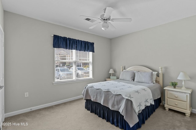 carpeted bedroom with a ceiling fan, visible vents, and baseboards