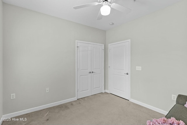 unfurnished room featuring ceiling fan, carpet floors, and baseboards