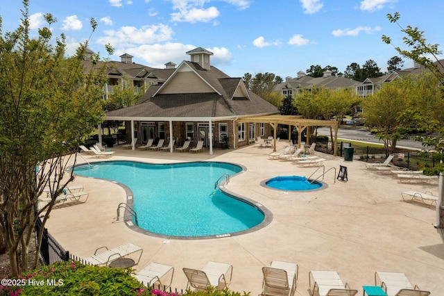 pool with fence, a pergola, and a patio