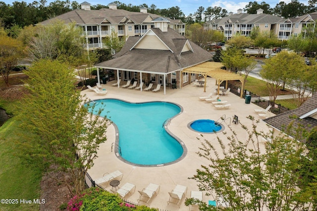 pool with a patio area, a residential view, and a pergola