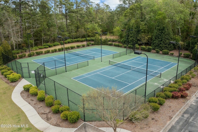 view of sport court featuring fence