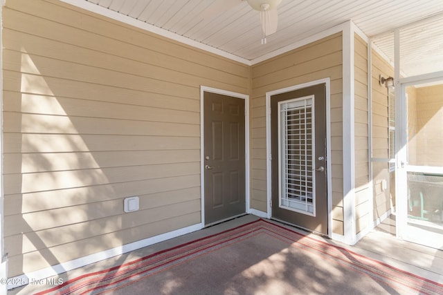 view of exterior entry featuring ceiling fan