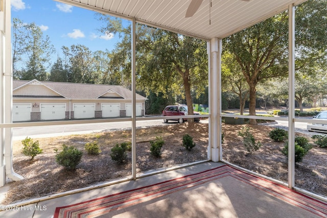 unfurnished sunroom with a wealth of natural light and ceiling fan