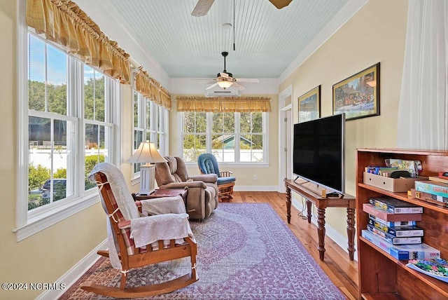 sunroom / solarium with a ceiling fan