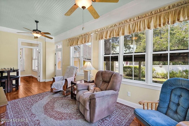 sunroom / solarium featuring a ceiling fan and a healthy amount of sunlight