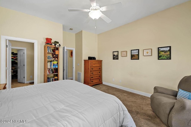 carpeted bedroom featuring a ceiling fan, visible vents, and baseboards