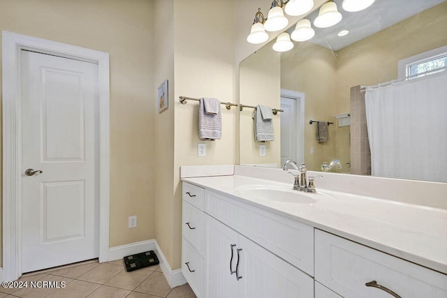 bathroom featuring baseboards, curtained shower, vanity, and tile patterned floors