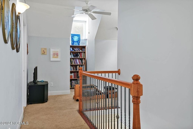 corridor featuring carpet, an upstairs landing, and baseboards