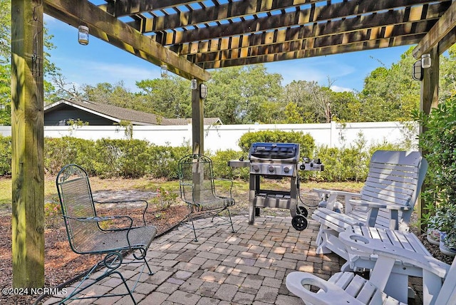 view of patio / terrace featuring a fenced backyard, a pergola, and area for grilling