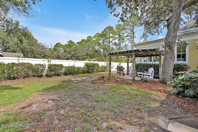 view of yard with a patio area, a fenced backyard, and a pergola