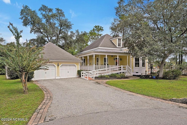 view of front of home featuring driveway, covered porch, a front lawn, and roof with shingles