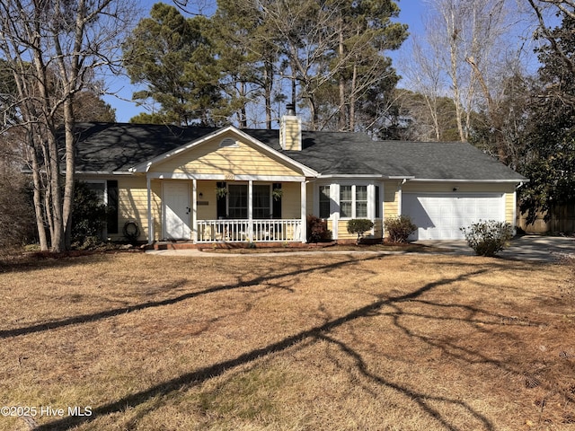 view of front of property featuring an attached garage, a chimney, a porch, and a front yard