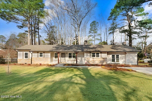 ranch-style house featuring a front lawn and a chimney