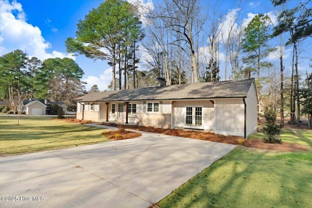 ranch-style house featuring a porch, a front yard, and a chimney