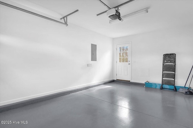 garage featuring a garage door opener, electric panel, and baseboards