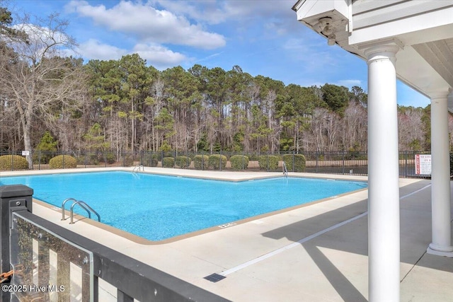 pool featuring a patio area and fence