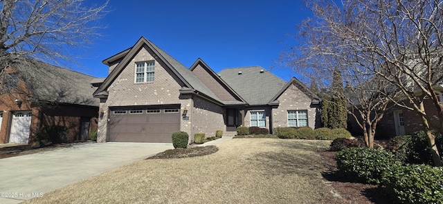 view of front facade featuring driveway, an attached garage, and brick siding