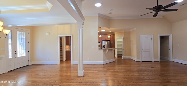 foyer featuring light wood-style floors, crown molding, and baseboards