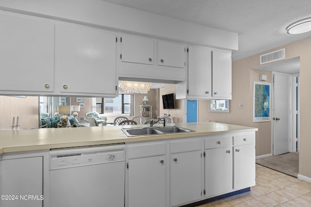 kitchen with visible vents, white dishwasher, light countertops, white cabinetry, and a sink