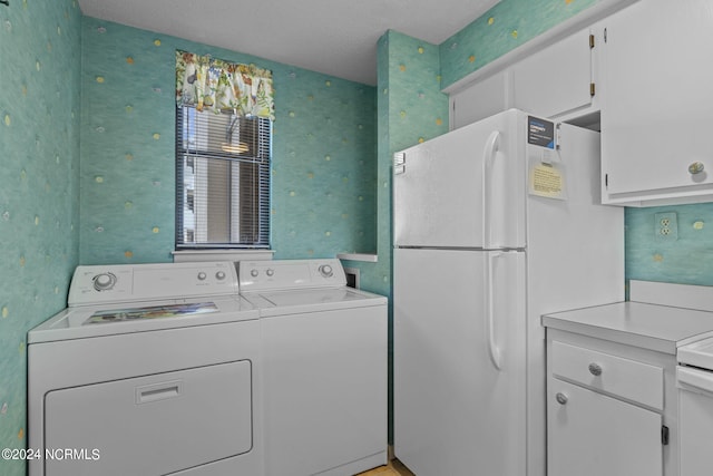 washroom featuring laundry area, washer and clothes dryer, and wallpapered walls