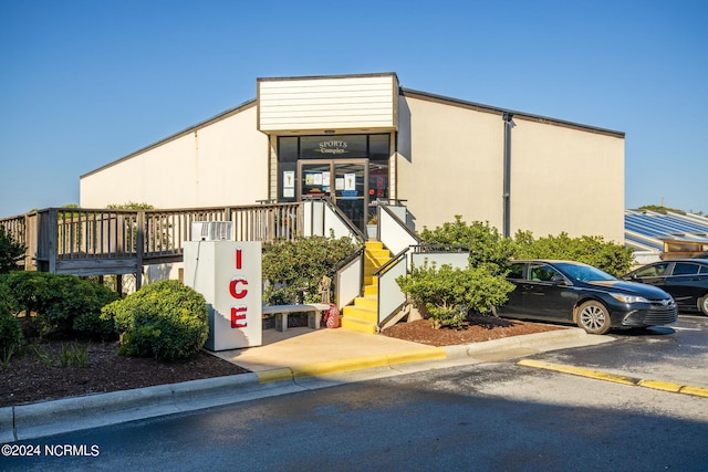 view of building exterior with uncovered parking