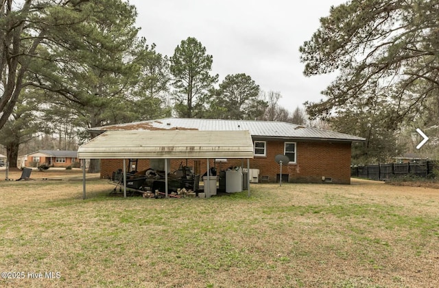 315 Glenfield Rd, Snow Hill, NC 28580 - back of house with metal roof, brick siding, fence, a yard, and crawl space