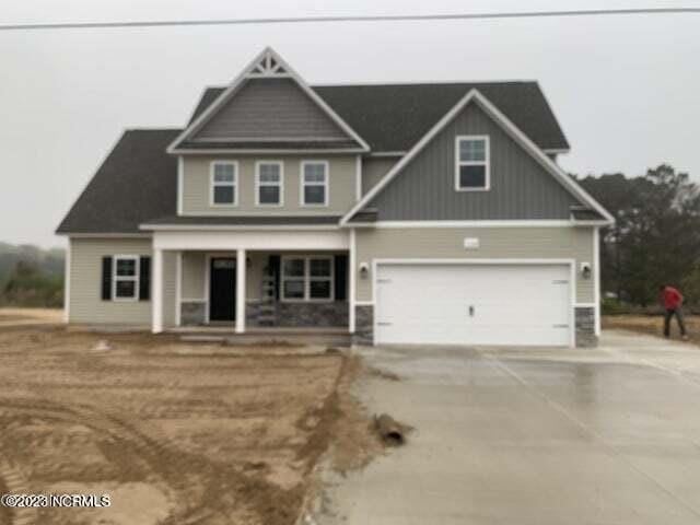 craftsman-style home featuring a porch, driveway, and a garage