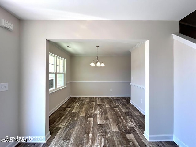 unfurnished dining area with baseboards, wood finished floors, visible vents, and a notable chandelier