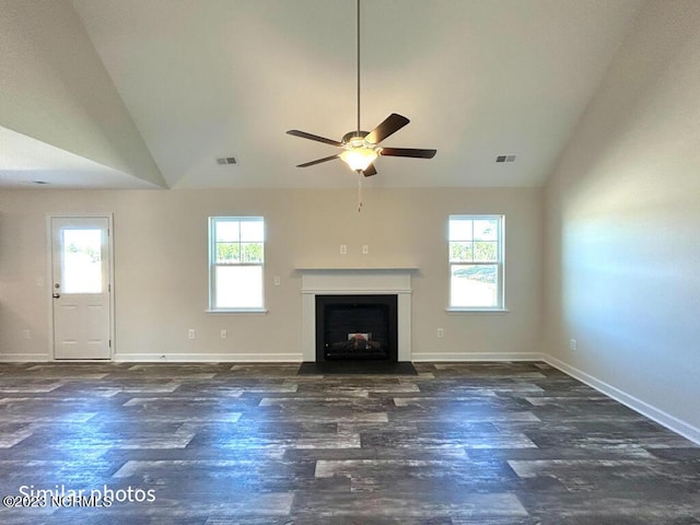 unfurnished living room featuring vaulted ceiling, a fireplace, wood finished floors, and visible vents