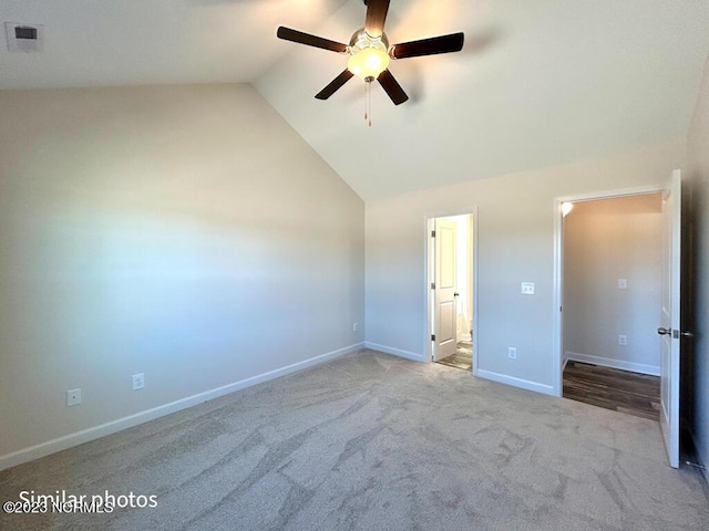 unfurnished bedroom with carpet floors, visible vents, a ceiling fan, vaulted ceiling, and baseboards