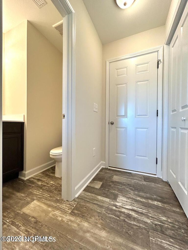 doorway to outside with wood finished floors and baseboards