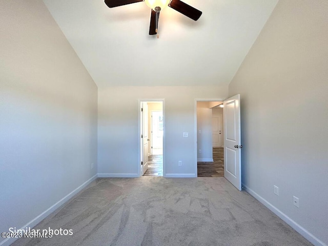 unfurnished bedroom with vaulted ceiling, carpet, a ceiling fan, and baseboards