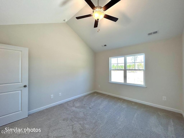 unfurnished room featuring lofted ceiling, visible vents, and baseboards